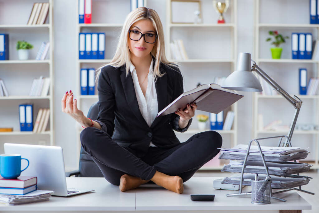 Woman staying calm while sitting on her desk
